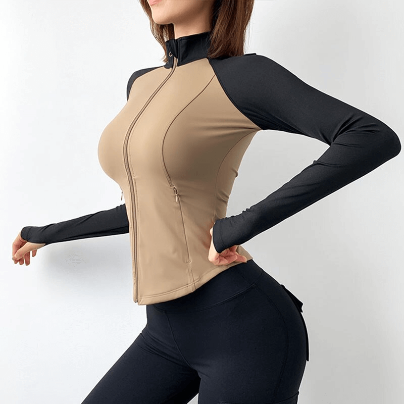 Woman modeling a two-tone slim sport jacket with long sleeves and zip, ideal for yoga and fitness, highlighting comfortable and stylish design.